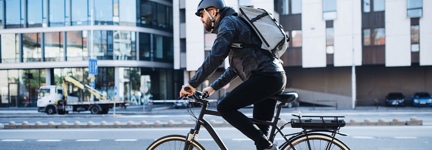 mężczyzna jedzie na rowerze przez miasto